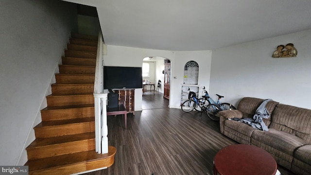 2209 Brighton St, Philadelphia, PA 19149 - living area featuring arched walkways, dark wood-style floors, and stairway