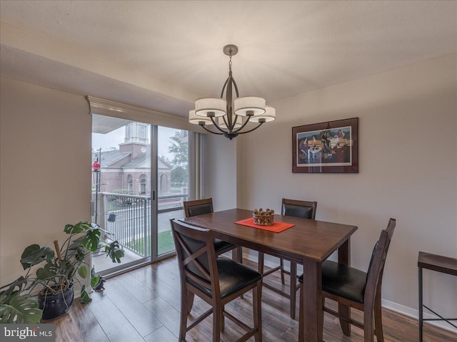 dining area featuring a chandelier and wood finished floors