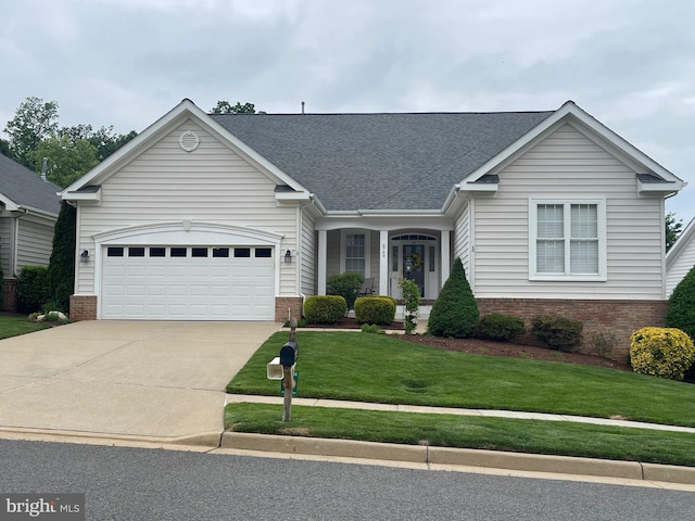view of front facade featuring brick siding, concrete driveway, and a front lawn