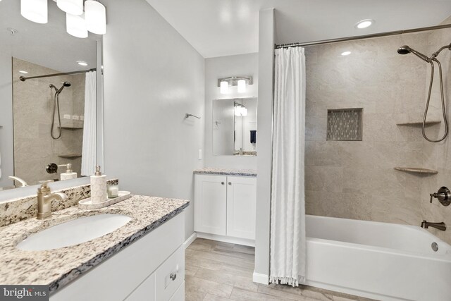full bath featuring shower / tub combo, two vanities, and recessed lighting