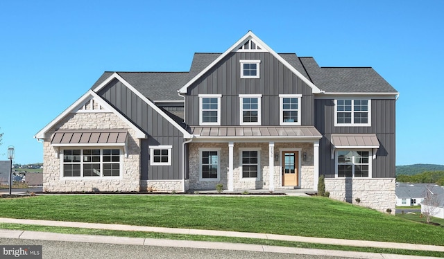 2030 N Fall Harvest Dr, Mechanicsburg, PA 17055 - view of front of home with a standing seam roof, roof with shingles, stone siding, and a porch