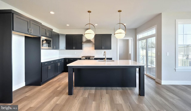 2030 N Fall Harvest Dr, Mechanicsburg, PA 17055 - kitchen with stainless steel microwave, a sink, backsplash, light wood-style flooring, and recessed lighting