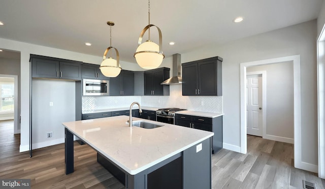 2030 N Fall Harvest Dr, Mechanicsburg, PA 17055 - kitchen with a sink, wall chimney range hood, stainless steel appliances, light wood finished floors, and tasteful backsplash