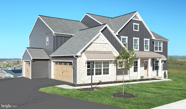 2030 N Fall Harvest Dr, Mechanicsburg, PA 17055 - view of front of house featuring an attached garage, driveway, stone siding, a front yard, and roof with shingles