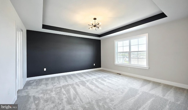 2030 N Fall Harvest Dr, Mechanicsburg, PA 17055 - empty room with a raised ceiling, a chandelier, baseboards, and carpet flooring