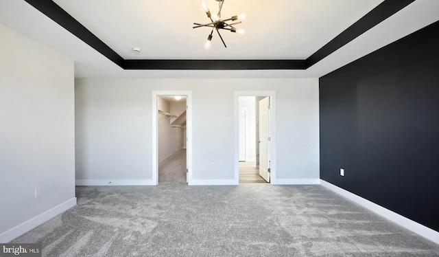 2030 N Fall Harvest Dr, Mechanicsburg, PA 17055 - unfurnished bedroom with carpet flooring, a tray ceiling, baseboards, a spacious closet, and a chandelier