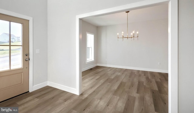 2030 N Fall Harvest Dr, Mechanicsburg, PA 17055 - unfurnished dining area featuring a chandelier, light wood-type flooring, and baseboards