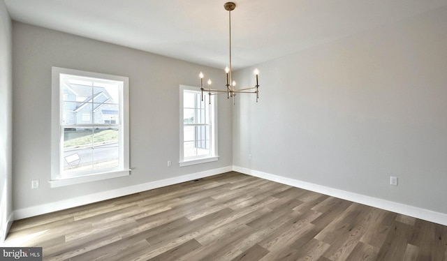 2030 N Fall Harvest Dr, Mechanicsburg, PA 17055 - unfurnished dining area with a chandelier, wood finished floors, and baseboards