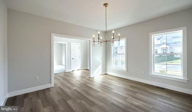 2030 N Fall Harvest Dr, Mechanicsburg, PA 17055 - unfurnished dining area with a chandelier, wood finished floors, and baseboards