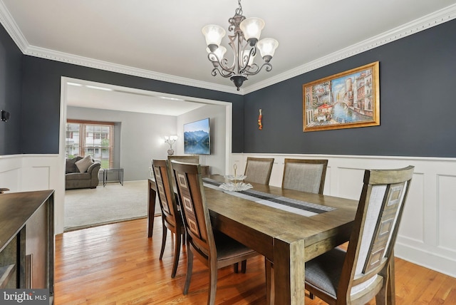 11 Moro Dr, Hamilton, NJ 08619 - dining room featuring a chandelier, wainscoting, ornamental molding, a decorative wall, and light wood-style floors