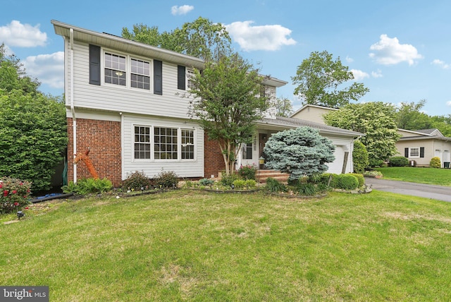 11 Moro Dr, Hamilton, NJ 08619 - colonial home with an attached garage, brick siding, asphalt driveway, and a front lawn