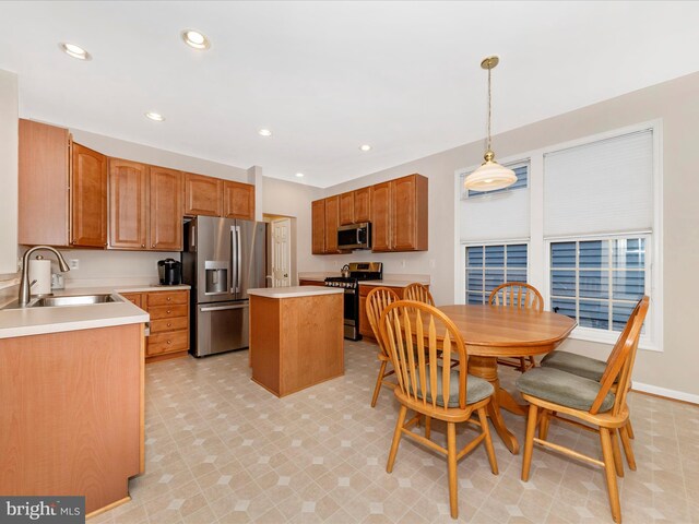 12318 Cherry Branch Dr, Clarksburg, MD 20871 - kitchen with stainless steel appliances, a sink, a kitchen island, light countertops, and pendant lighting