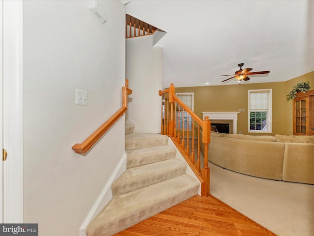 12318 Cherry Branch Dr, Clarksburg, MD 20871 - stairs featuring a ceiling fan, wood finished floors, and a fireplace