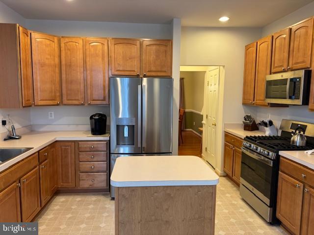12318 Cherry Branch Dr, Clarksburg, MD 20871 - kitchen with stainless steel appliances, light flooring, recessed lighting, and brown cabinets