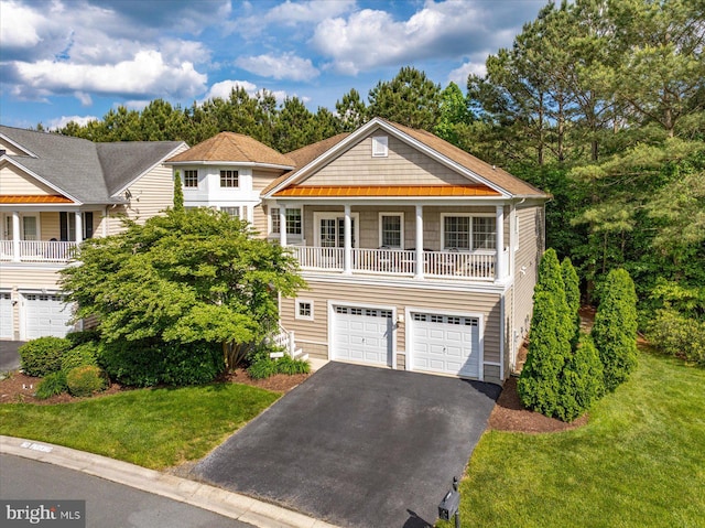 8705 Habitat Ct, Berlin, MD 21811 - view of front of home with asphalt driveway, a garage, and a front yard
