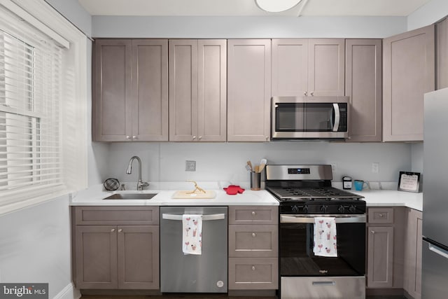 2456 20th St NW Unit 507, Washington, DC 20009 - kitchen featuring stainless steel appliances, a sink, light countertops, and baseboards