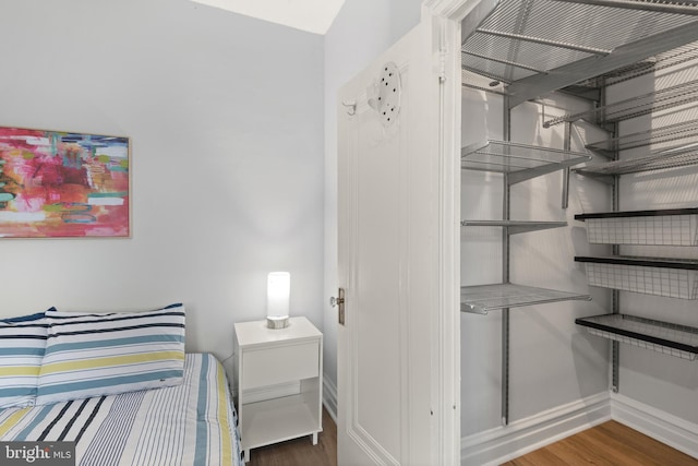 2456 20th St NW Unit 507, Washington, DC 20009 - bedroom with baseboards and wood finished floors