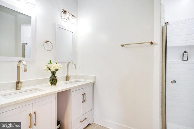 bathroom featuring double vanity and a tile shower