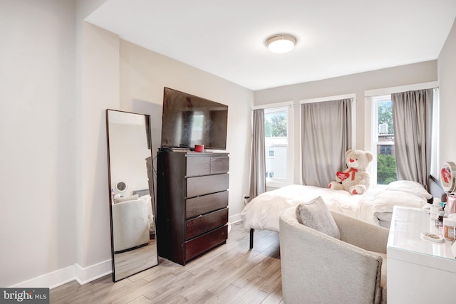 bedroom featuring baseboards and light wood-type flooring