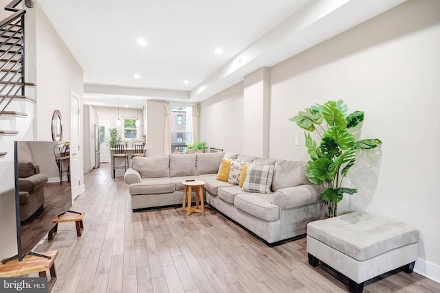living area featuring light wood-style floors, stairs, and recessed lighting