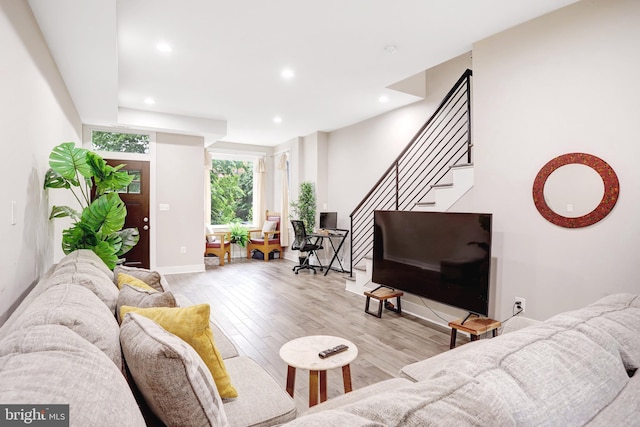 living room featuring wood finished floors, stairway, recessed lighting, and baseboards