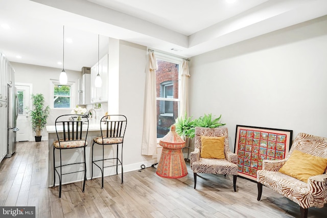 dining area with light wood finished floors, recessed lighting, and baseboards