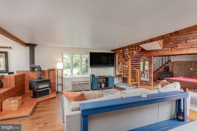 7430 Joes Creek Rd, Linville, VA 22834 - living area with a wood stove, stairs, wood finished floors, and log walls