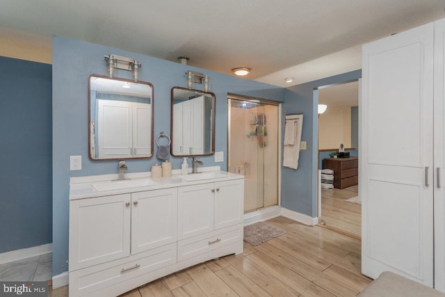 7430 Joes Creek Rd, Linville, VA 22834 - full bathroom with baseboards, a stall shower, double vanity, and wood finished floors