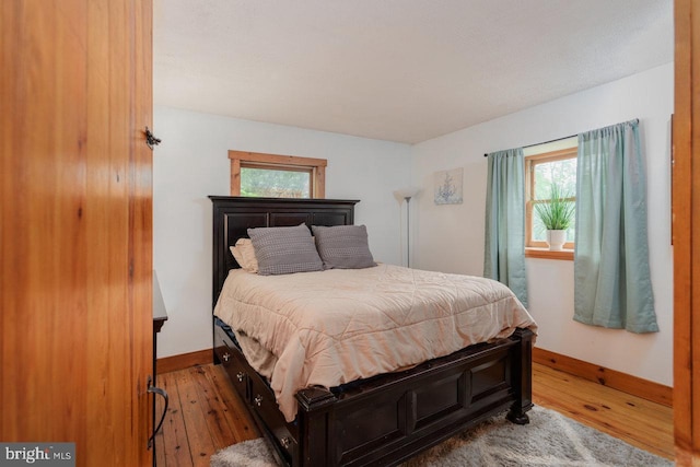 7430 Joes Creek Rd, Linville, VA 22834 - bedroom with baseboards, hardwood / wood-style floors, and multiple windows