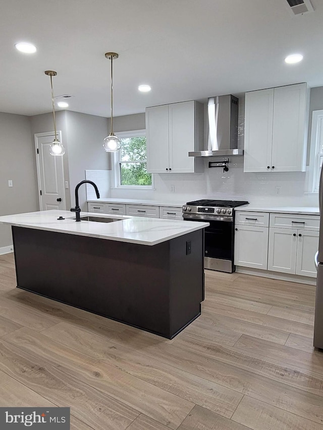 5209 10th Pl S, Arlington, VA 22204 - kitchen featuring stainless steel appliances, wall chimney range hood, a sink, light wood-style flooring, and recessed lighting