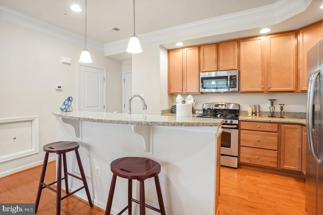444 Exchange Ave Unit 444, Gaithersburg, MD 20878 - kitchen with appliances with stainless steel finishes, ornamental molding, a kitchen bar, light wood-style floors, and light stone countertops