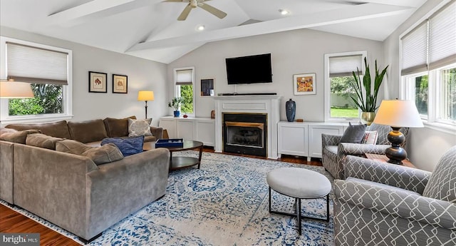 living room featuring wood finished floors, ceiling fan, vaulted ceiling, a fireplace, and recessed lighting