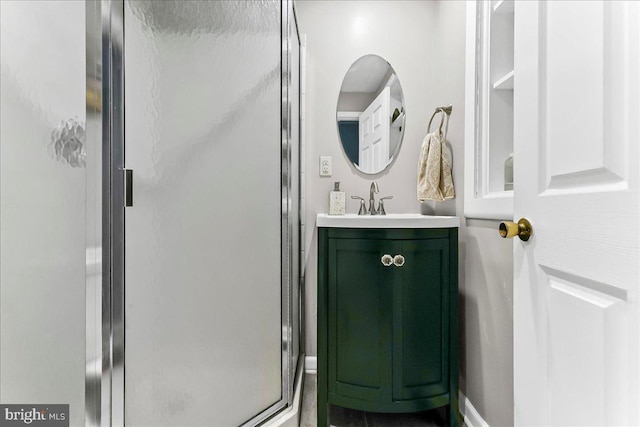 bathroom with a stall shower and vanity