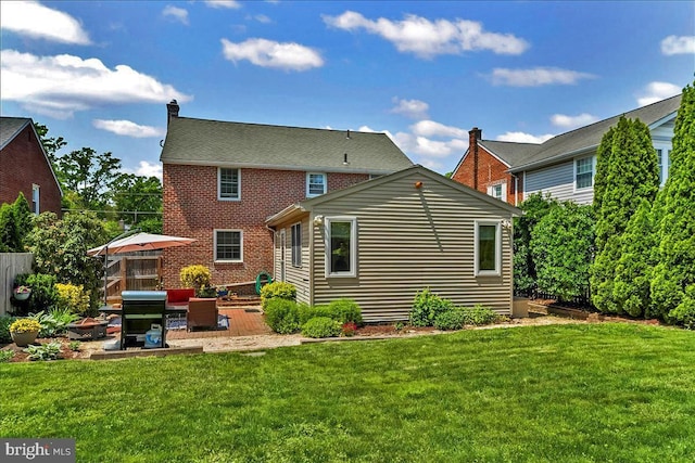 back of house with a patio and brick siding