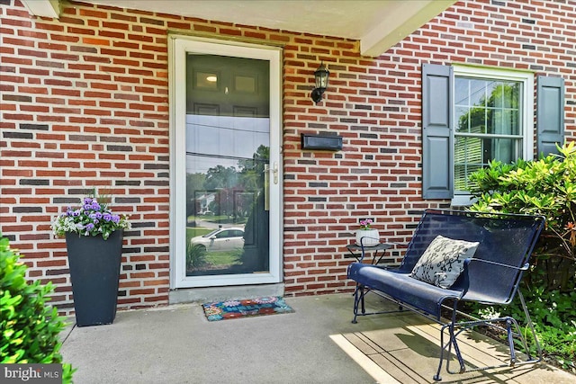 property entrance featuring brick siding