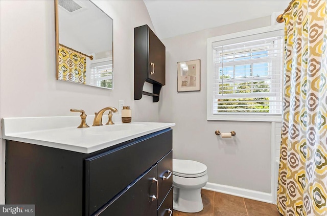 full bath featuring plenty of natural light, toilet, vanity, and tile patterned floors