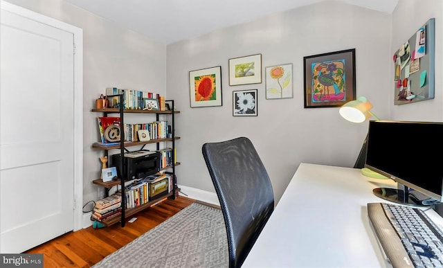 office space featuring wood finished floors and baseboards