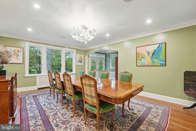 4301 Forest Ln NW, Washington, DC 20007 - dining area with arched walkways, ornamental molding, wood finished floors, baseboards, and a chandelier