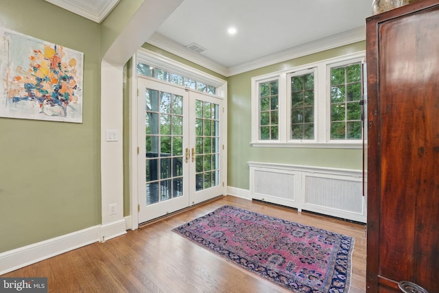 4301 Forest Ln NW, Washington, DC 20007 - entryway with radiator heating unit, ornamental molding, french doors, baseboards, and wood finished floors