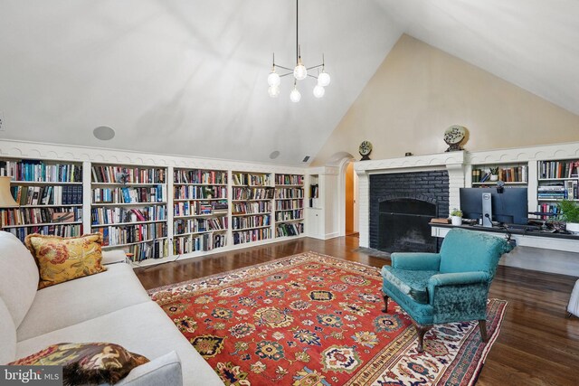 4301 Forest Ln NW, Washington, DC 20007 - living room featuring a brick fireplace, wood finished floors, built in features, and high vaulted ceiling