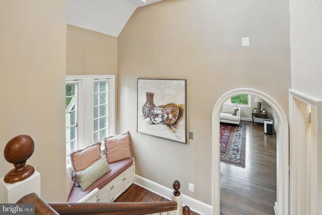 4301 Forest Ln NW, Washington, DC 20007 - staircase featuring wood finished floors, baseboards, high vaulted ceiling, and arched walkways