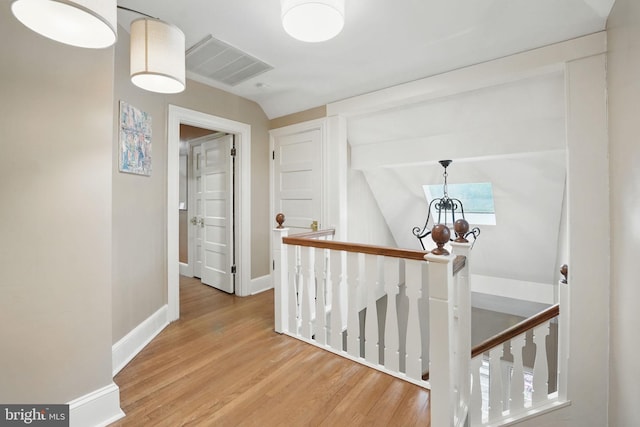 4301 Forest Ln NW, Washington, DC 20007 - hall with an upstairs landing, wood finished floors, baseboards, lofted ceiling, and a chandelier