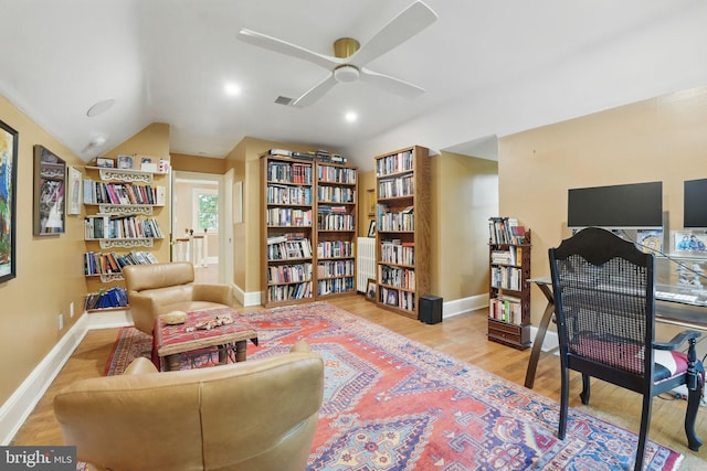 4301 Forest Ln NW, Washington, DC 20007 - sitting room featuring wood finished floors, baseboards, ceiling fan, wall of books, and lofted ceiling