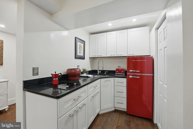 4301 Forest Ln NW, Washington, DC 20007 - kitchen with freestanding refrigerator, dark wood finished floors, recessed lighting, black electric cooktop, and white cabinets