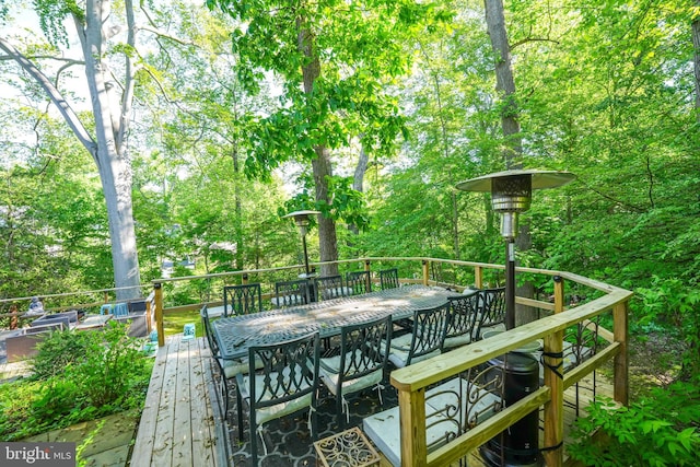 4301 Forest Ln NW, Washington, DC 20007 - deck featuring outdoor dining space and view of wooded area
