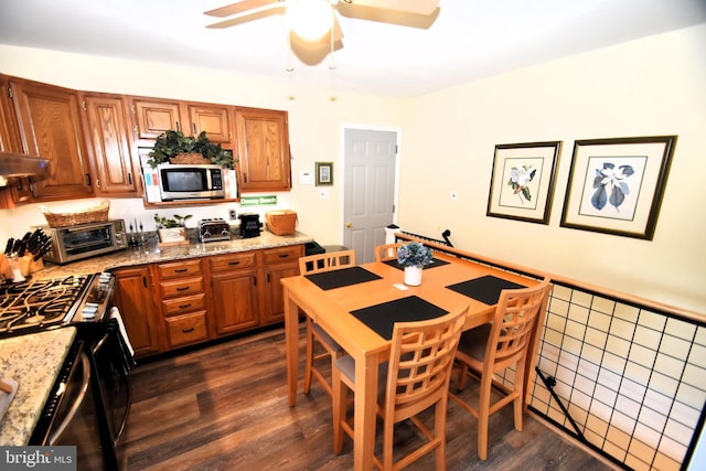 10 Casimir Ct, New Castle, DE 19720 - kitchen featuring stainless steel microwave, brown cabinetry, ceiling fan, and light stone counters