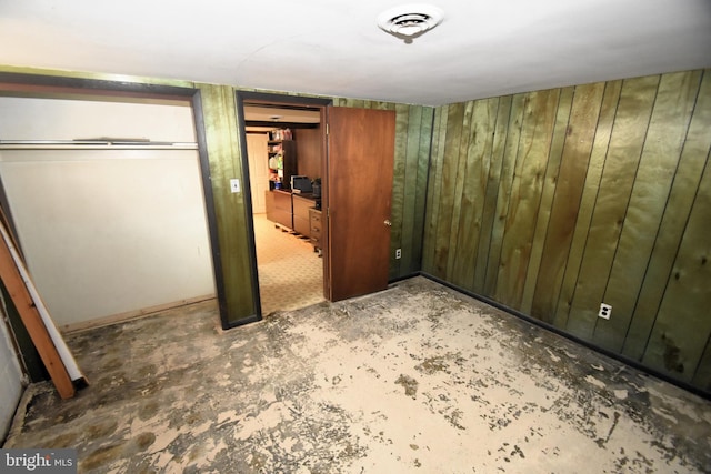 10 Casimir Ct, New Castle, DE 19720 - unfurnished bedroom featuring concrete flooring and wooden walls