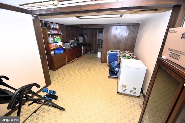 10 Casimir Ct, New Castle, DE 19720 - finished basement with wooden walls, fridge, an office area, and light colored carpet