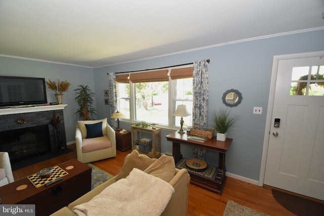 10 Casimir Ct, New Castle, DE 19720 - living room with ornamental molding, wood finished floors, baseboards, and a brick fireplace