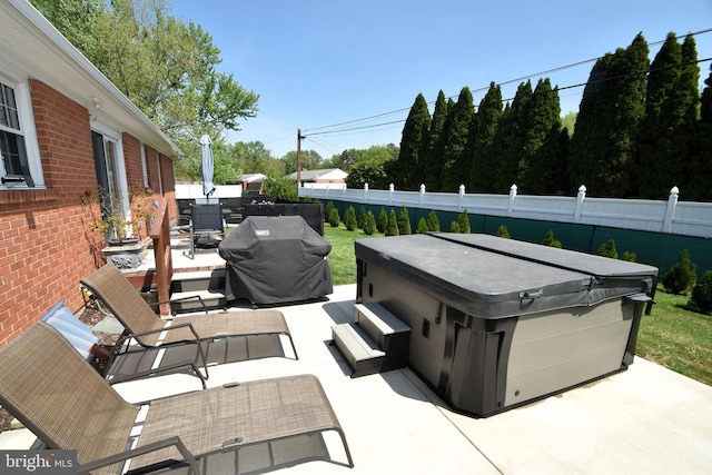 10 Casimir Ct, New Castle, DE 19720 - view of patio / terrace with a hot tub, fence, and an outdoor living space